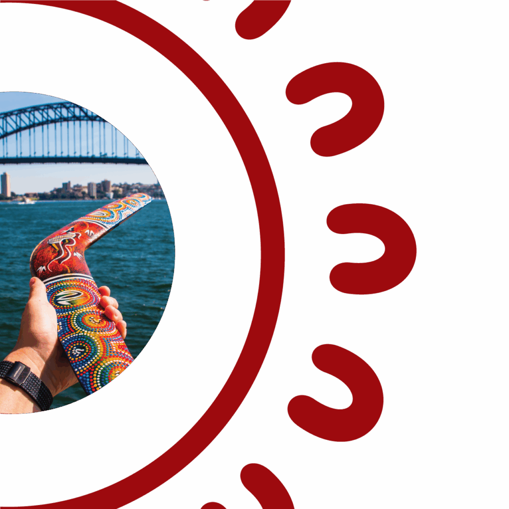 A hand holding a vibrantly painted Aboriginal dot art boomerang in front of Sydney Harbour, with the Sydney Harbour Bridge visible in the background, framed by the SCS Indigenous decorative red circular border featuring repeating U-shaped symbols inspired by Aboriginal art motifs, on a white background